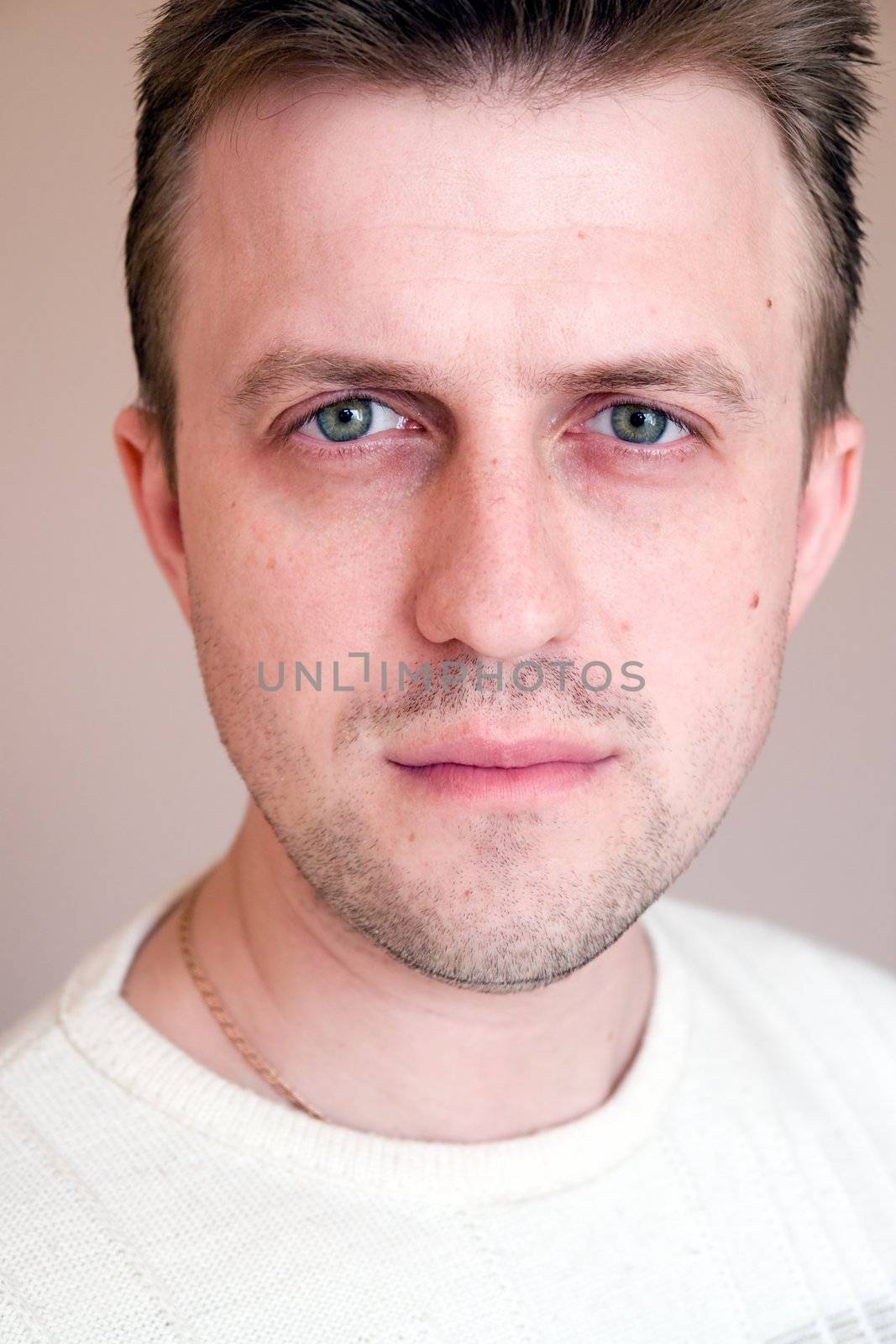 The serious young man close up.