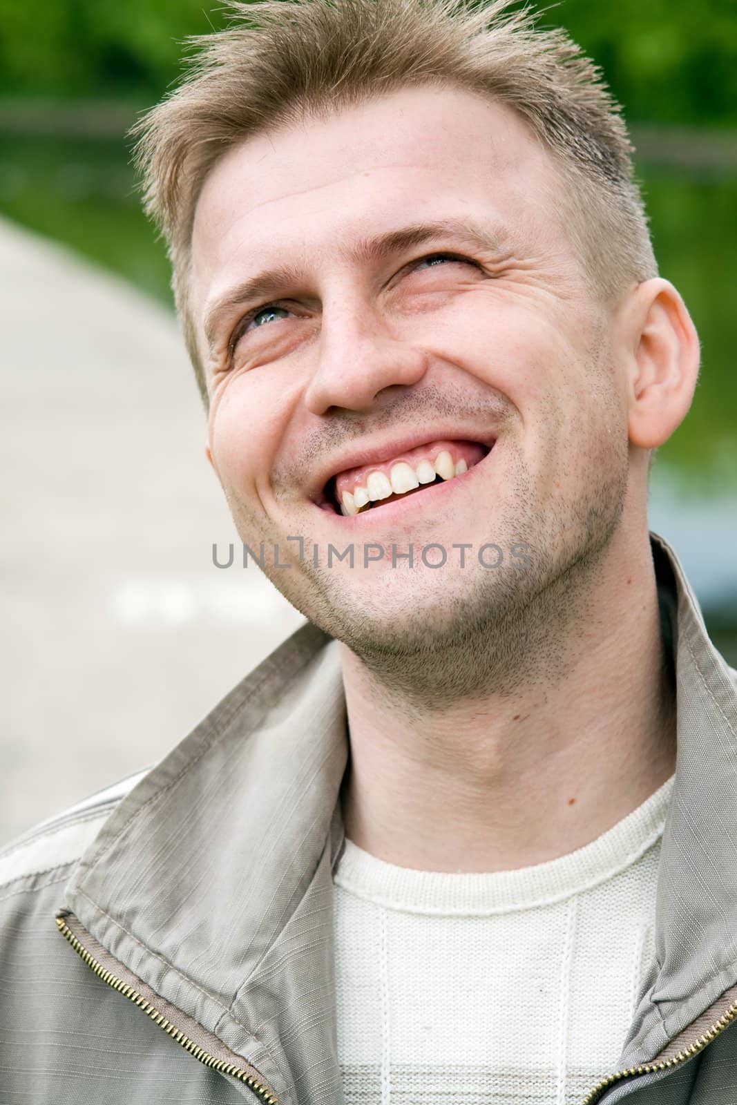 The smiling young man looks upward