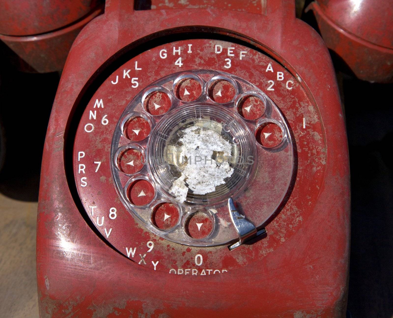 Old red rotary phone. by iofoto