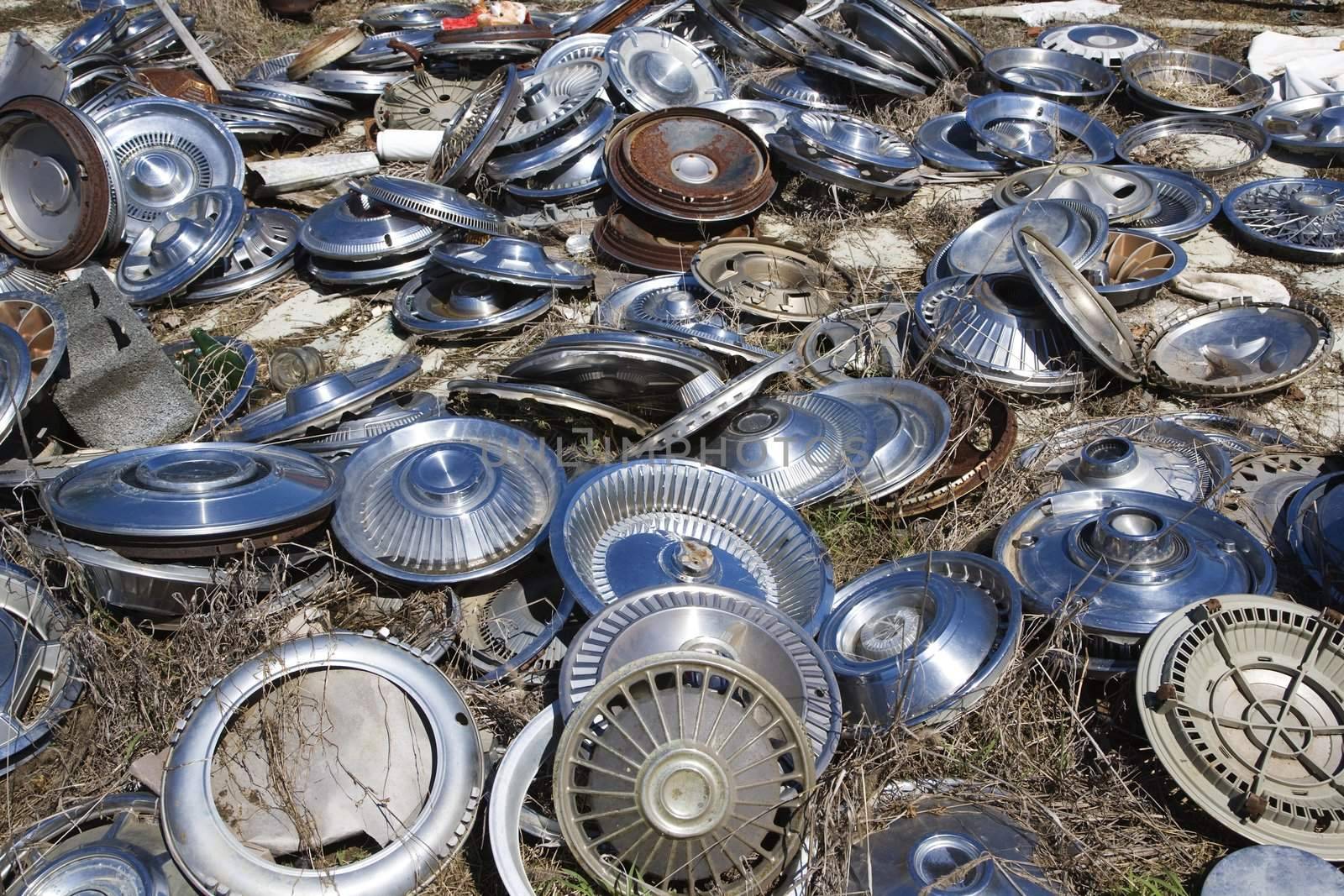 Old metal hubcaps strewn across the ground.