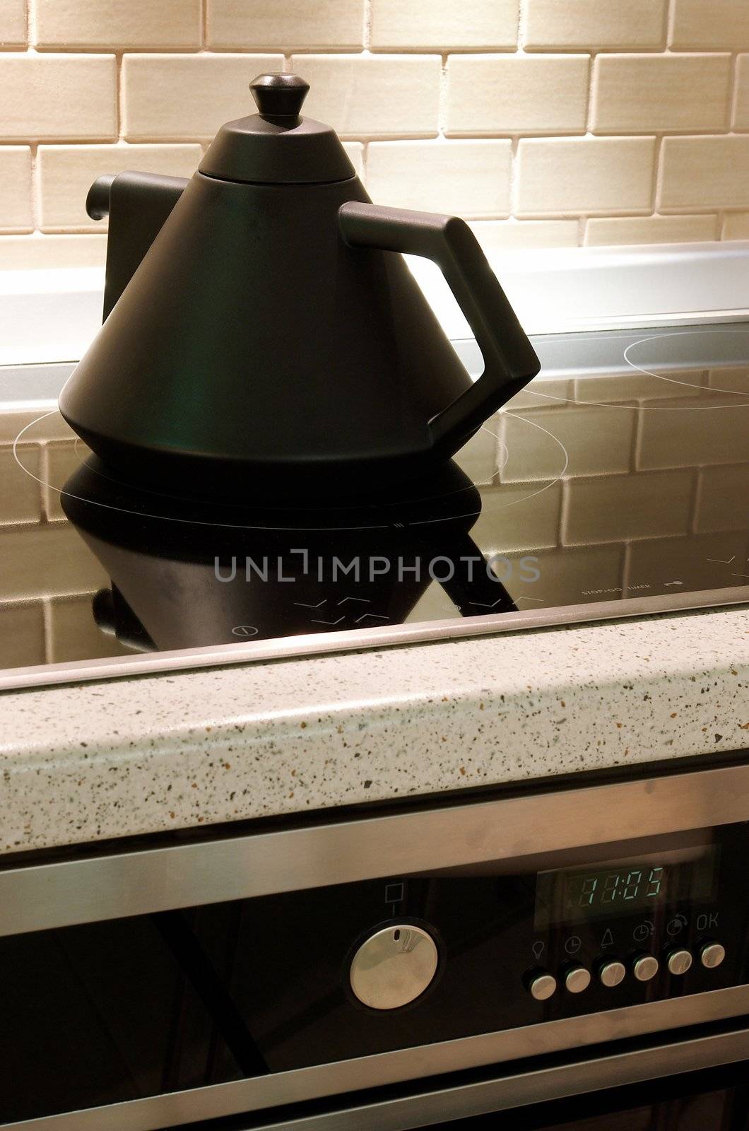 Teapot on an electric plate with clocks