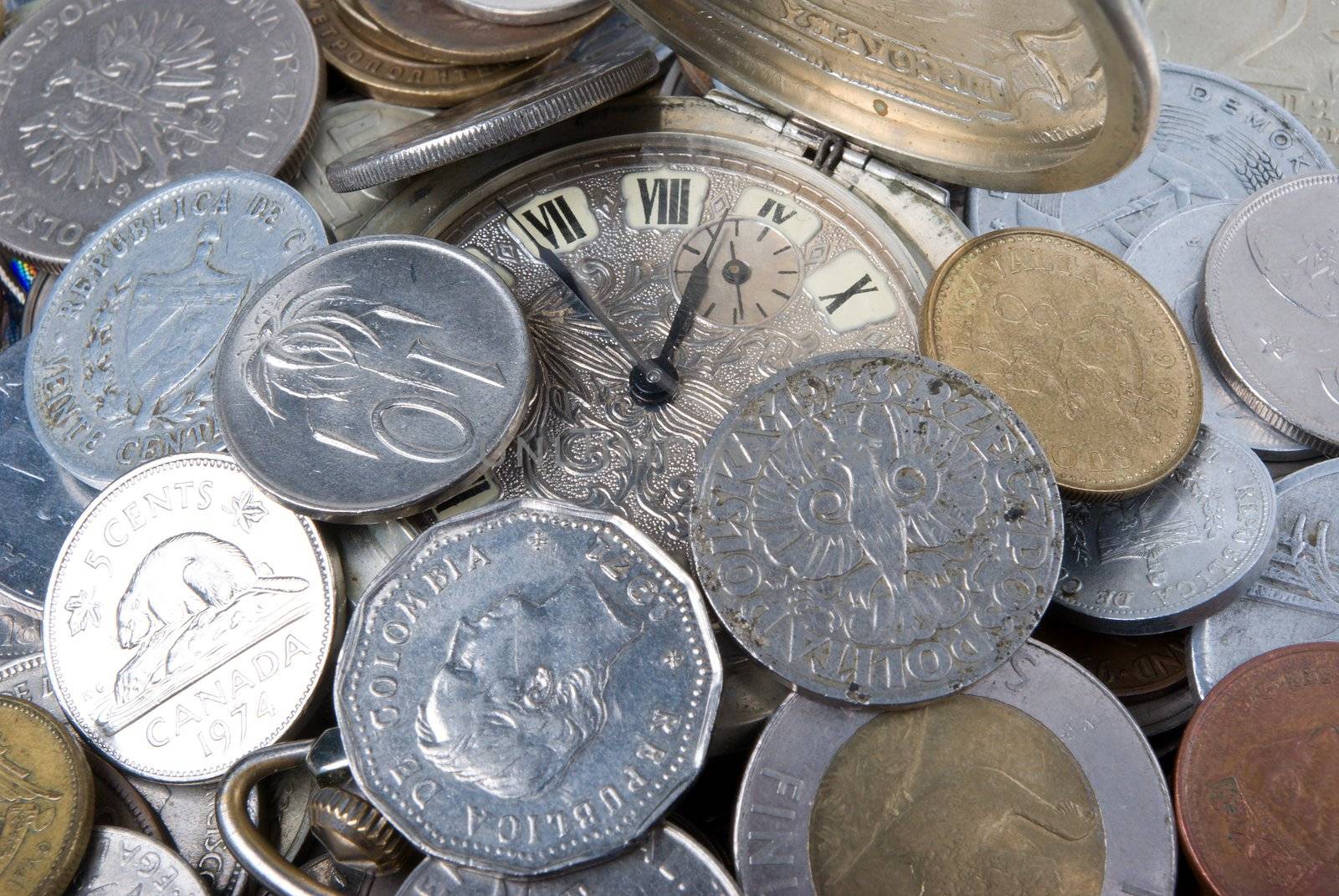 coins and old watch,money of the different countries and timeses