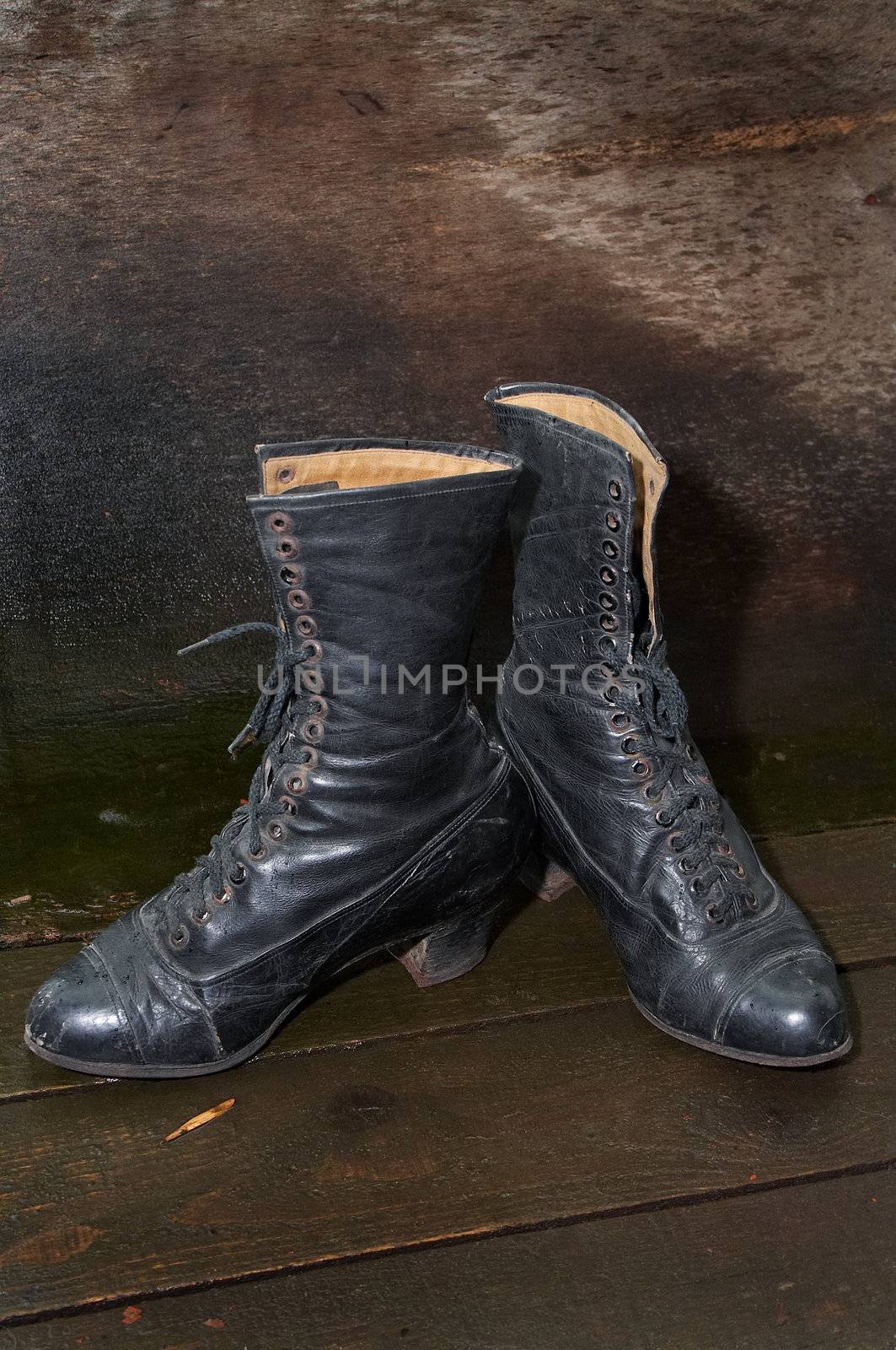 Old female boots on wooden to a floor