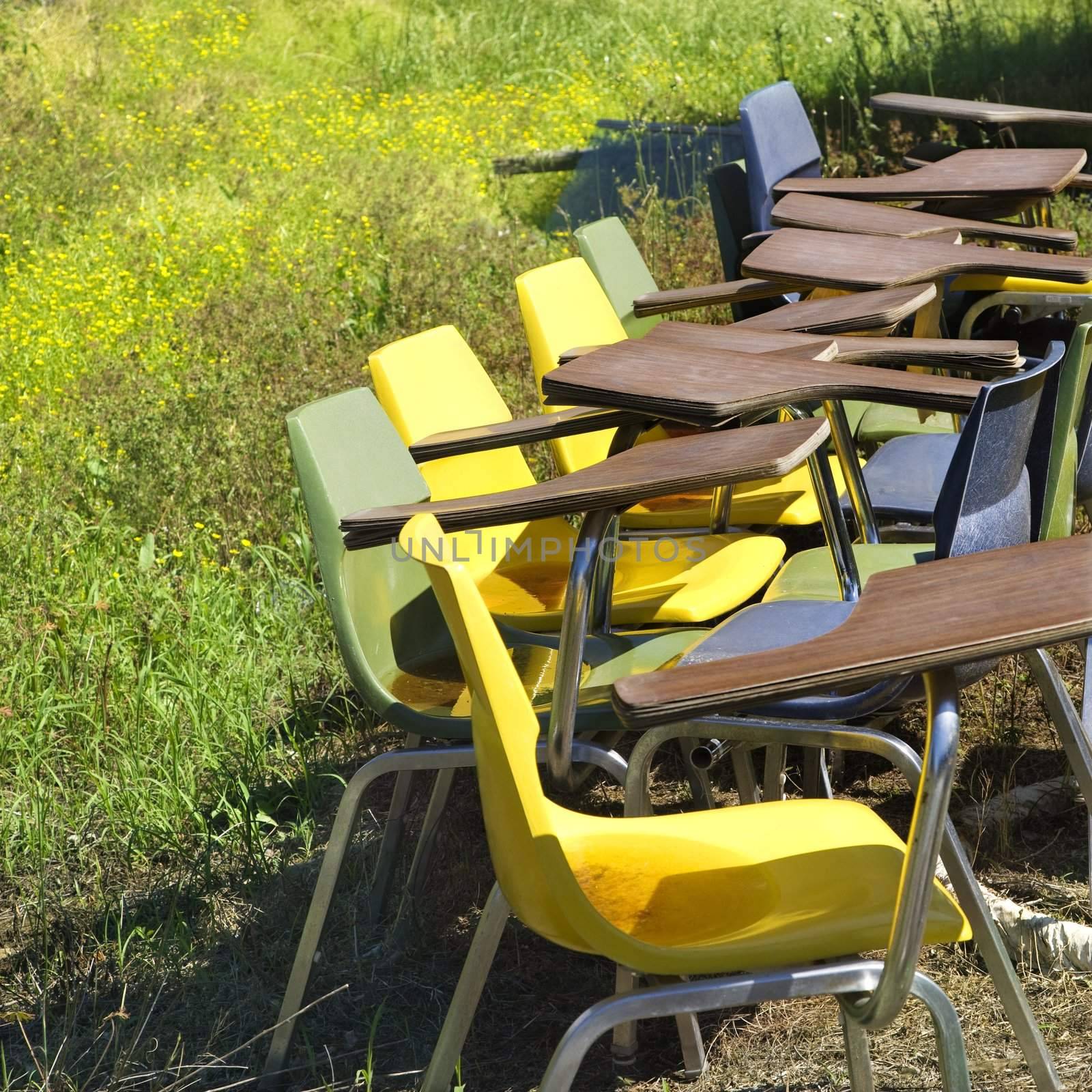 Old chairs in field. by iofoto