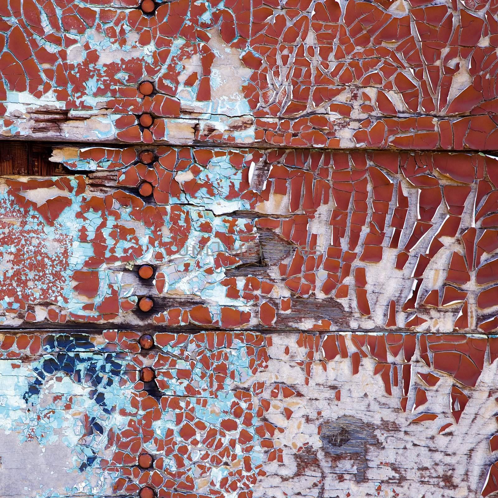 Side of wall with peeling paint.