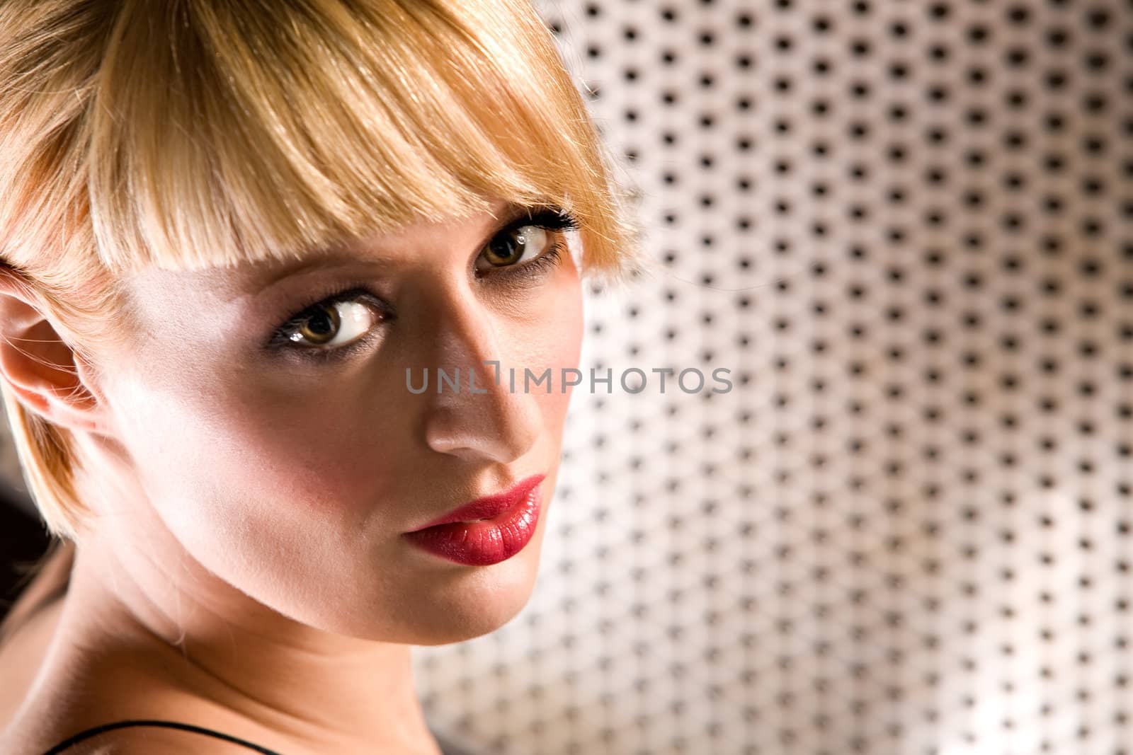 Portrait of a beautiful blond girl looking at you