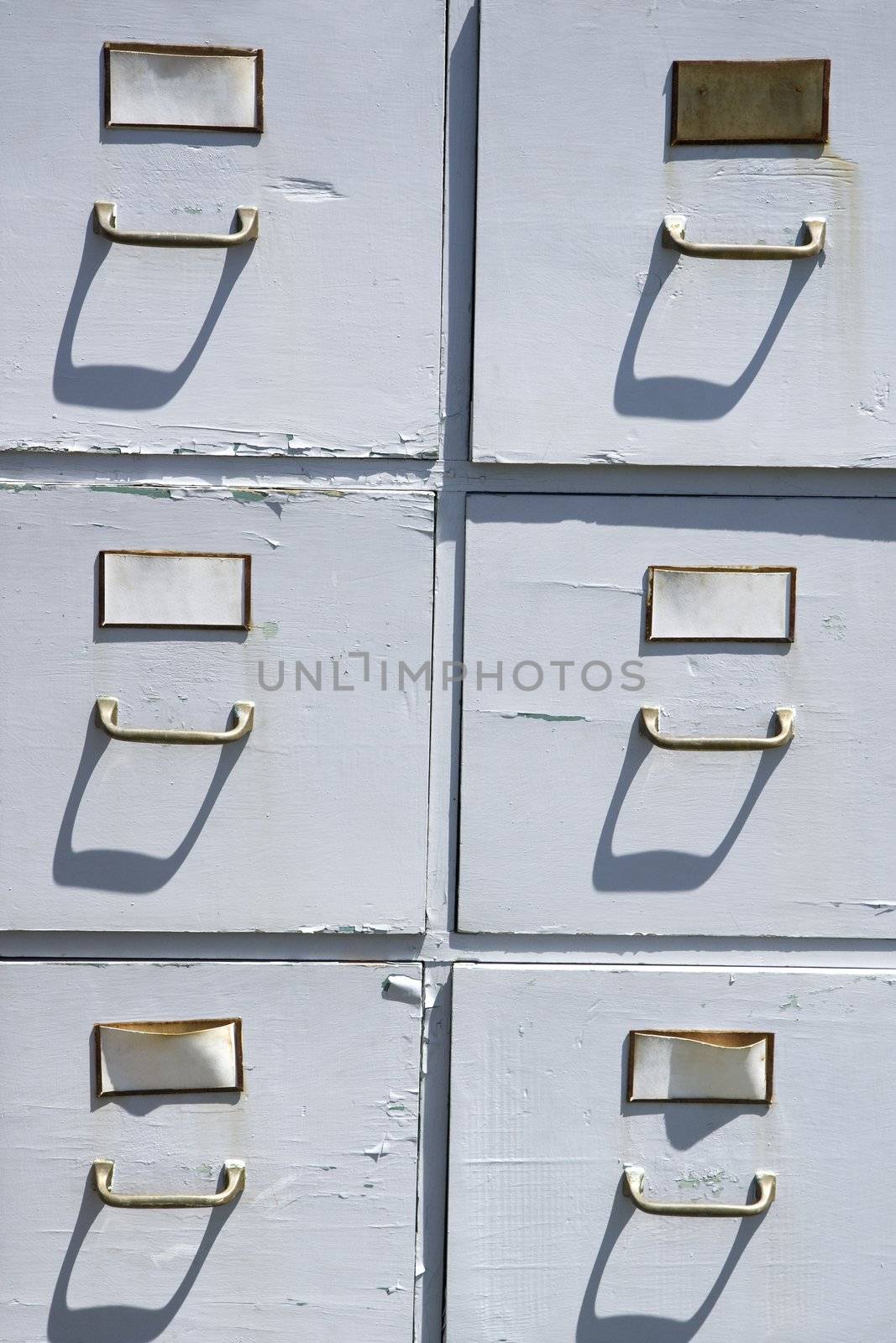 Old weathered grey cabinet outdoors.