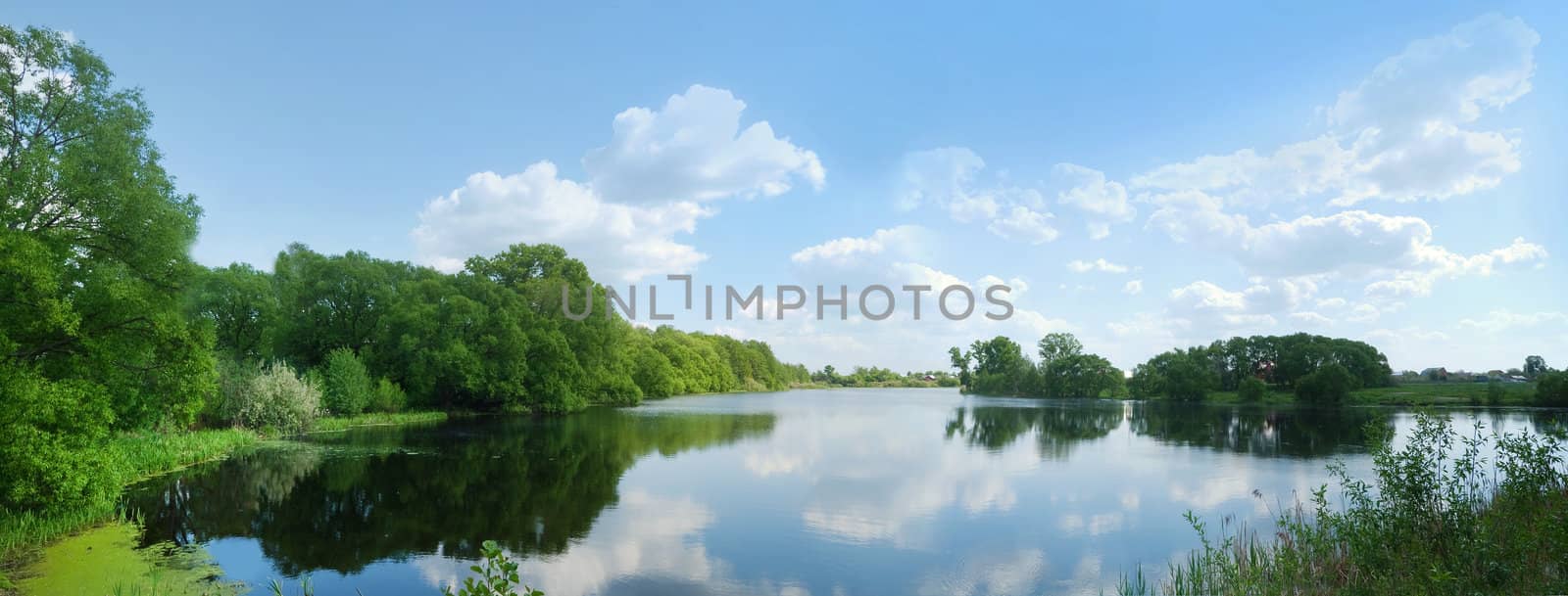 Beautiful contryside view with blue sky, lake and clouds