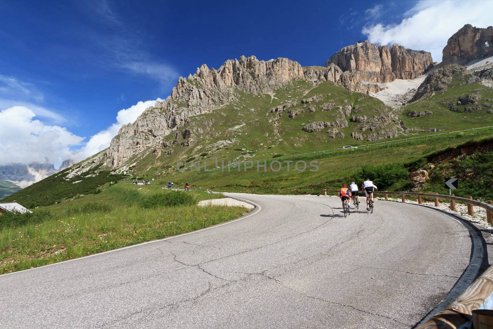 bikers on the road from Canazei to Pordoi pass, Trentino, Italy