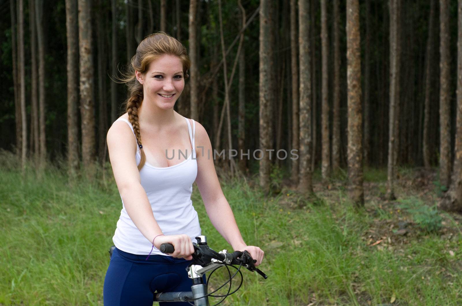 Active girl woman in forest with mountain bike
