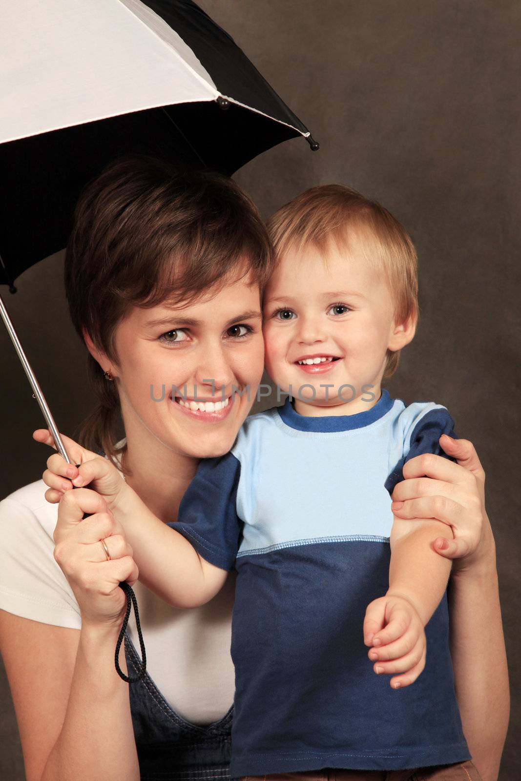  Mother with the child under a umbrella in studio