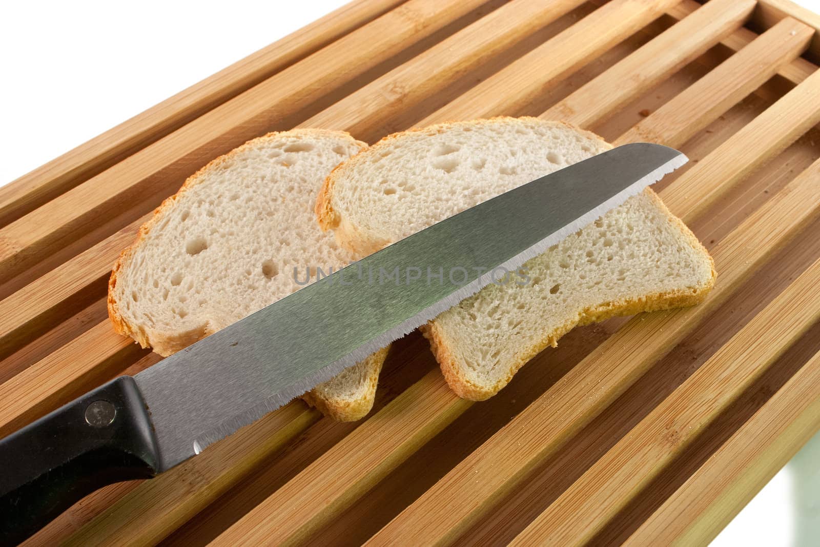 Bread chopping board with knife and slices of white bread