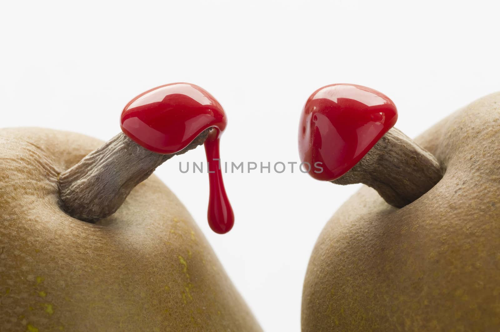 Green pears with red sealing wax on stalk