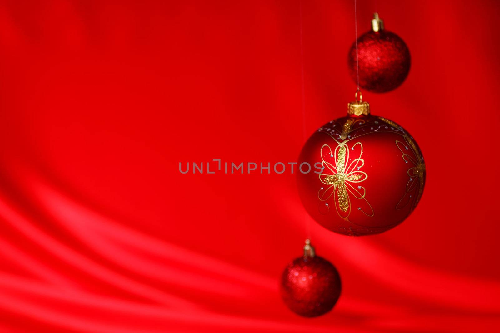  christmas balls on red satin background