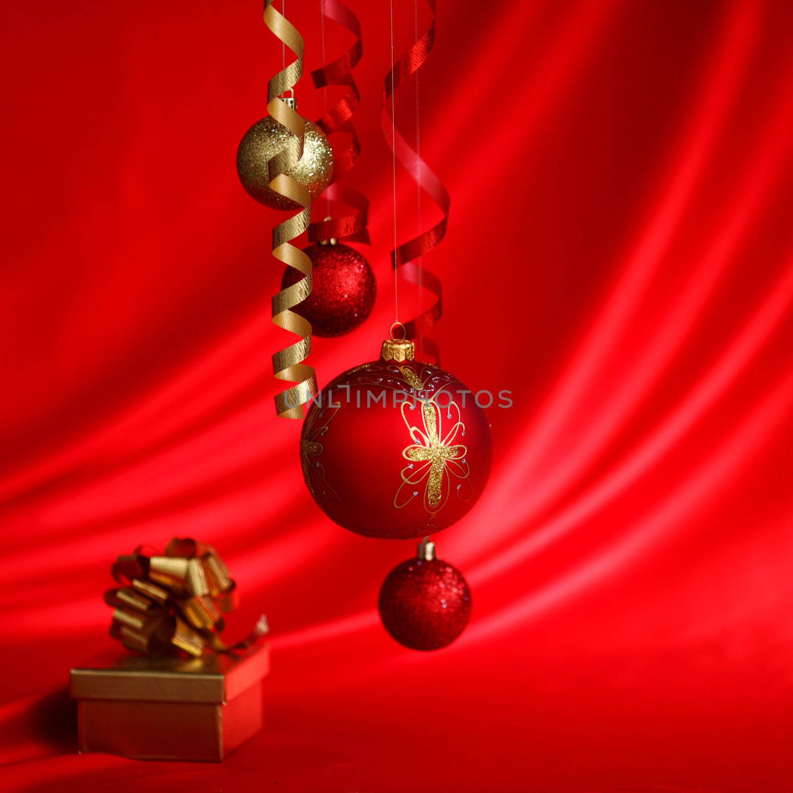  christmas balls on red satin background