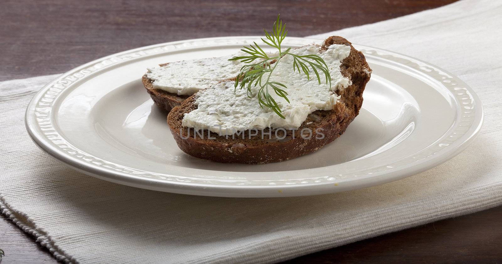 Sandwich with cottage cheese and dill on the white plate