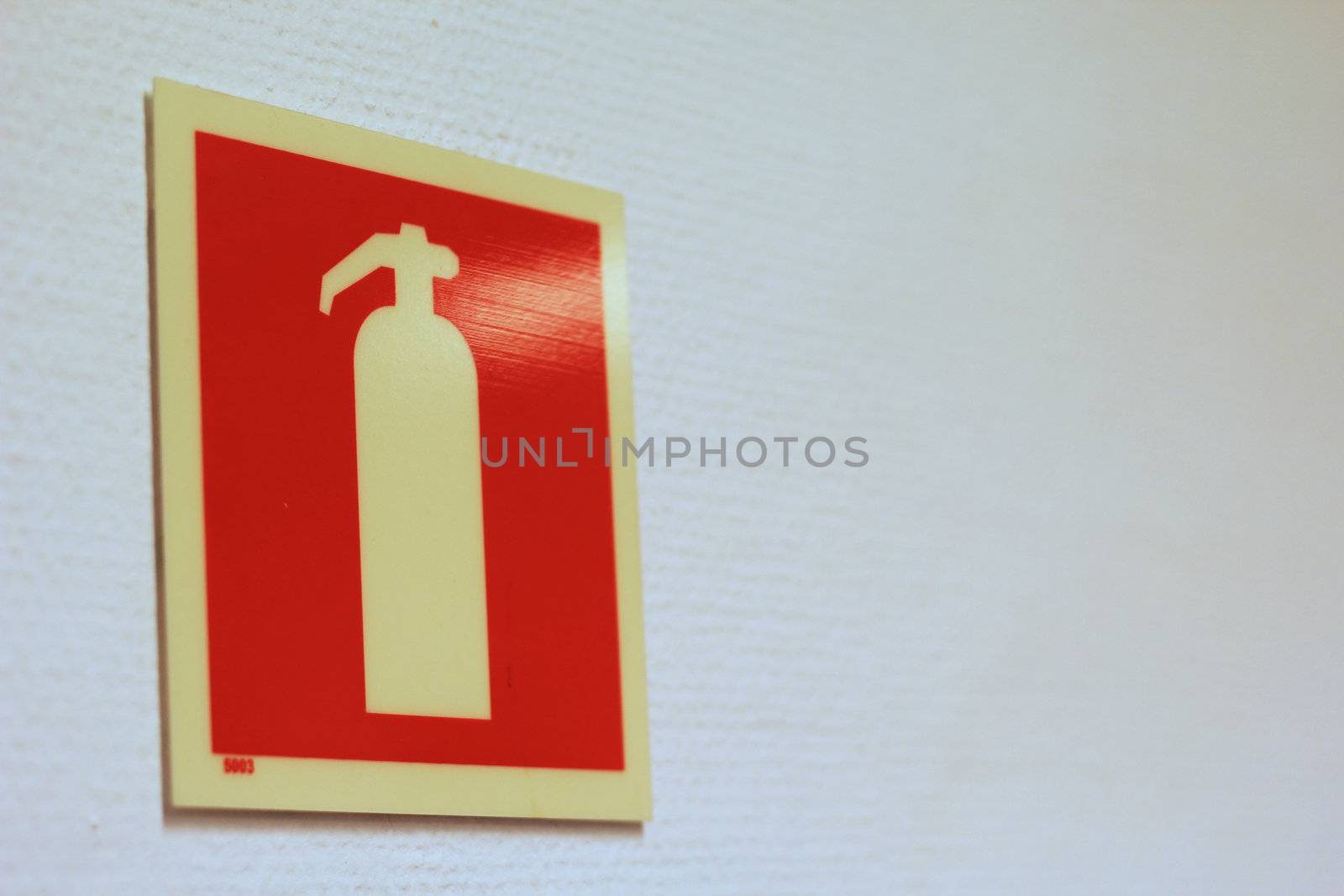Fire extinguisher sign on office wall
