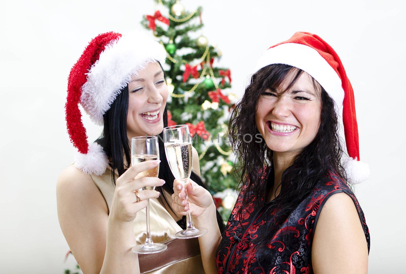 Christmas: two girls in red hat have fun 