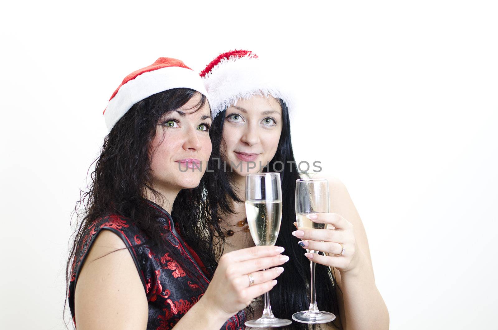 Christmas: two girls in red hat have fun 