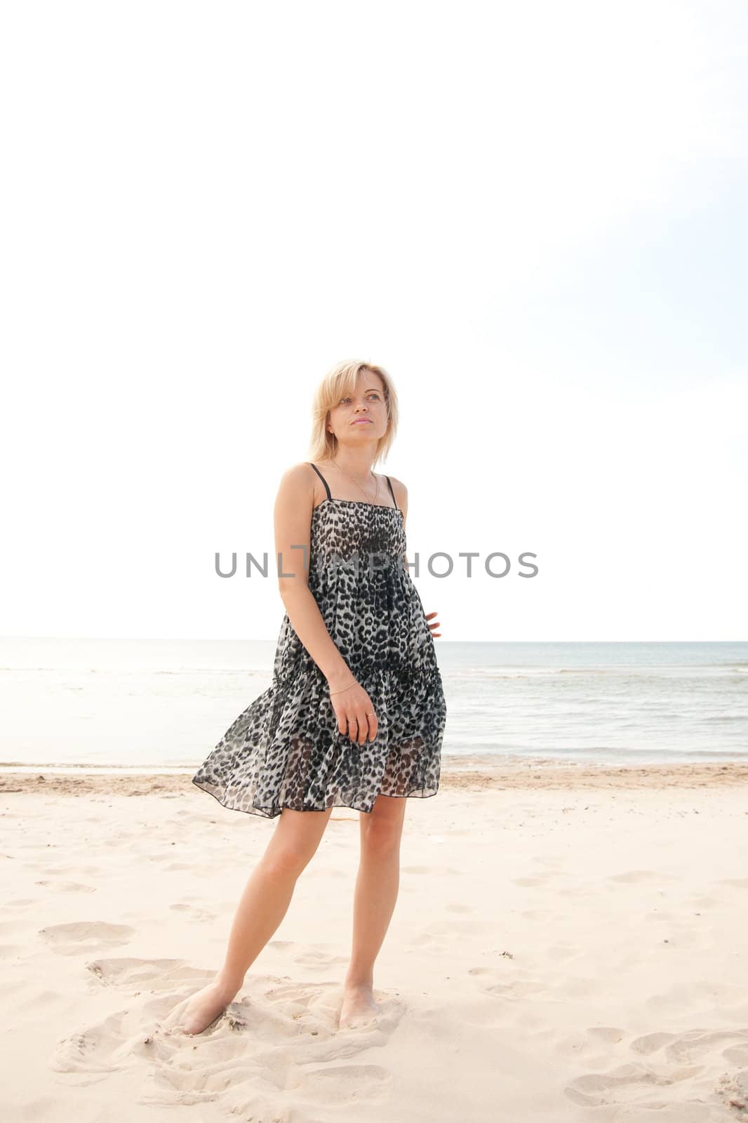 woman on the beach watching into the distance