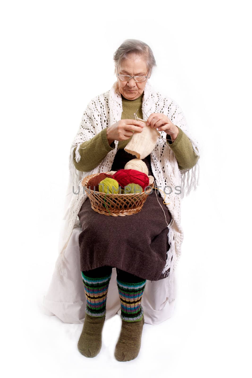 Senior woman knitting isolated on white background