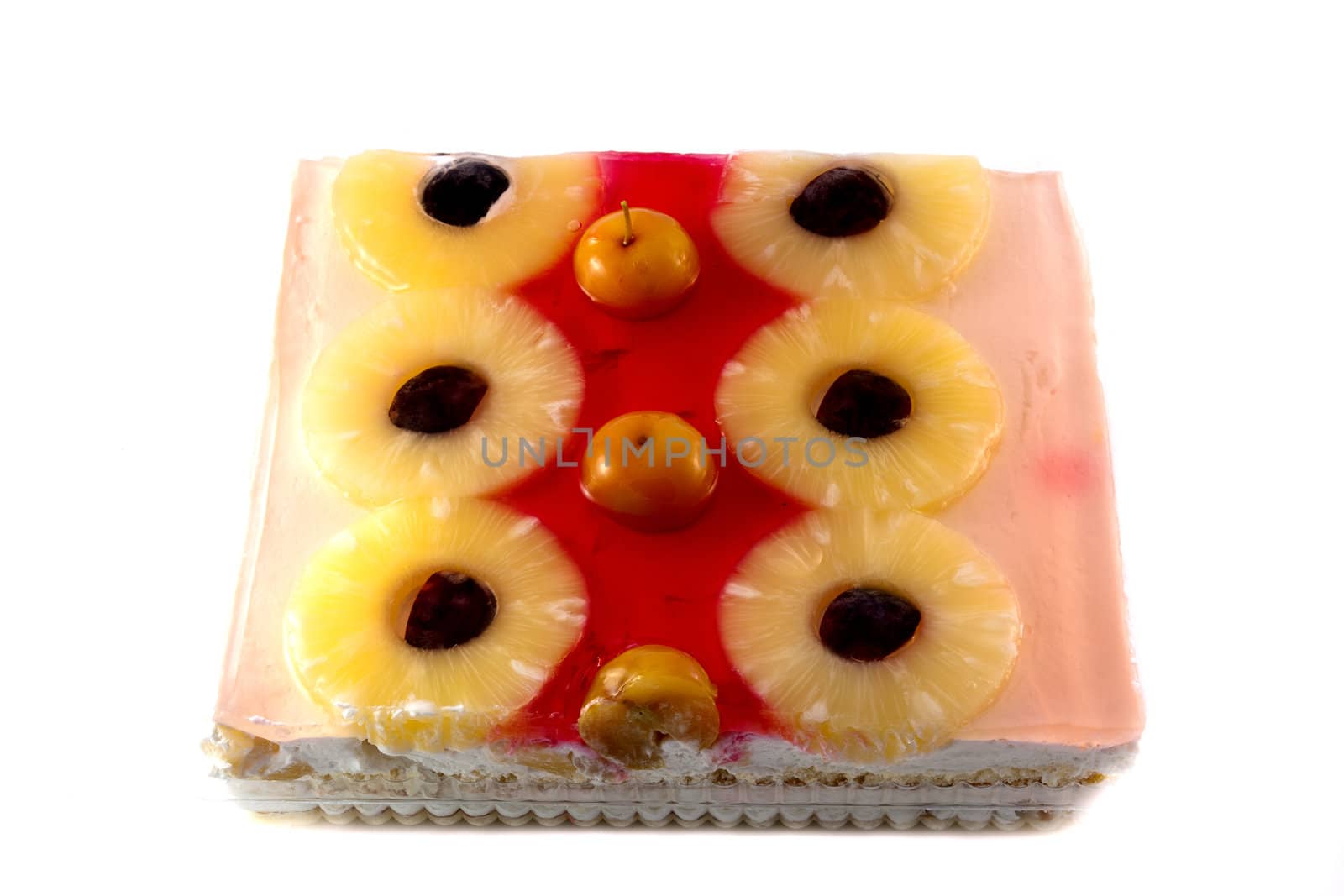 cake with jelly and fruits over white