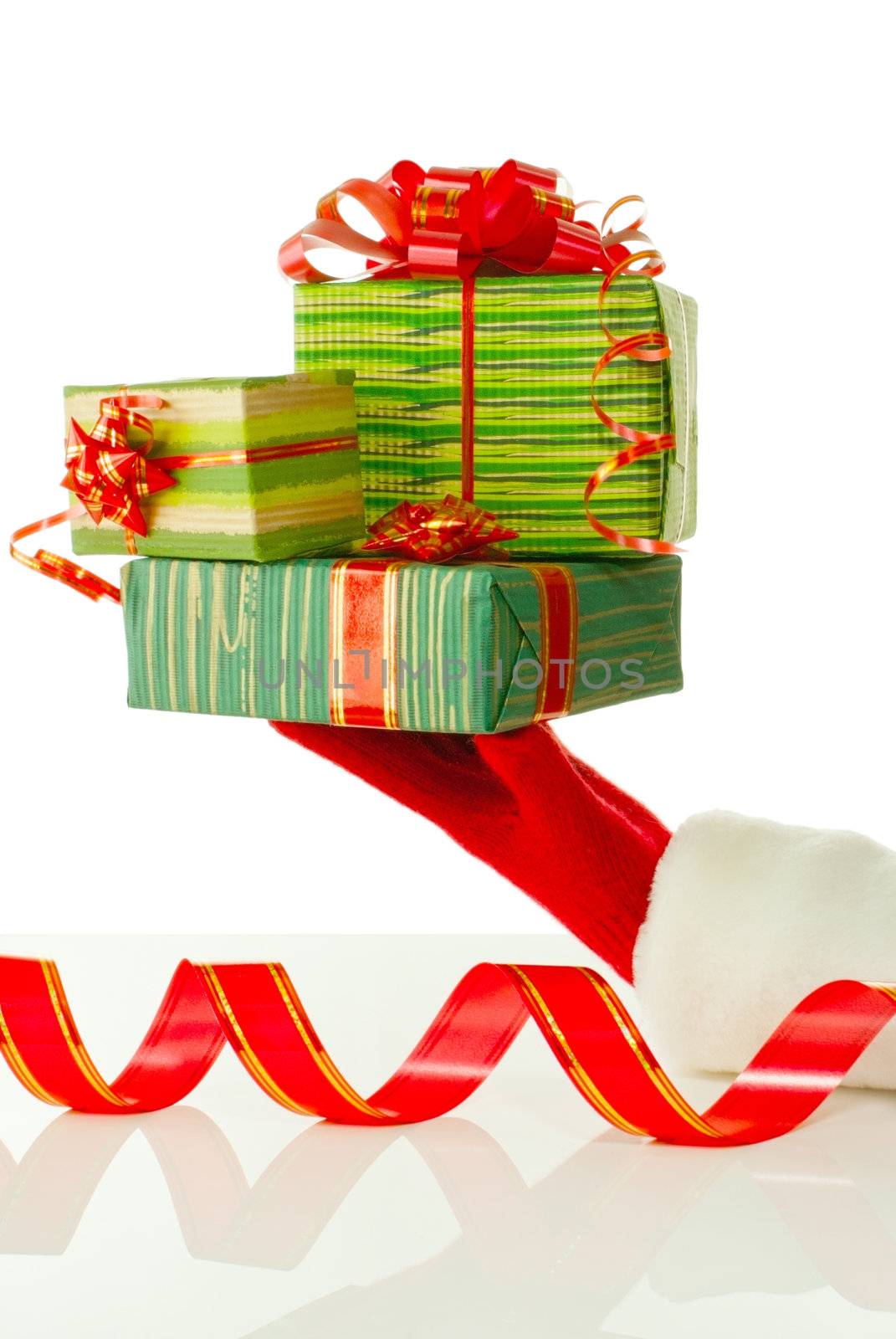 Santa's hand holding Christmas presents against white background