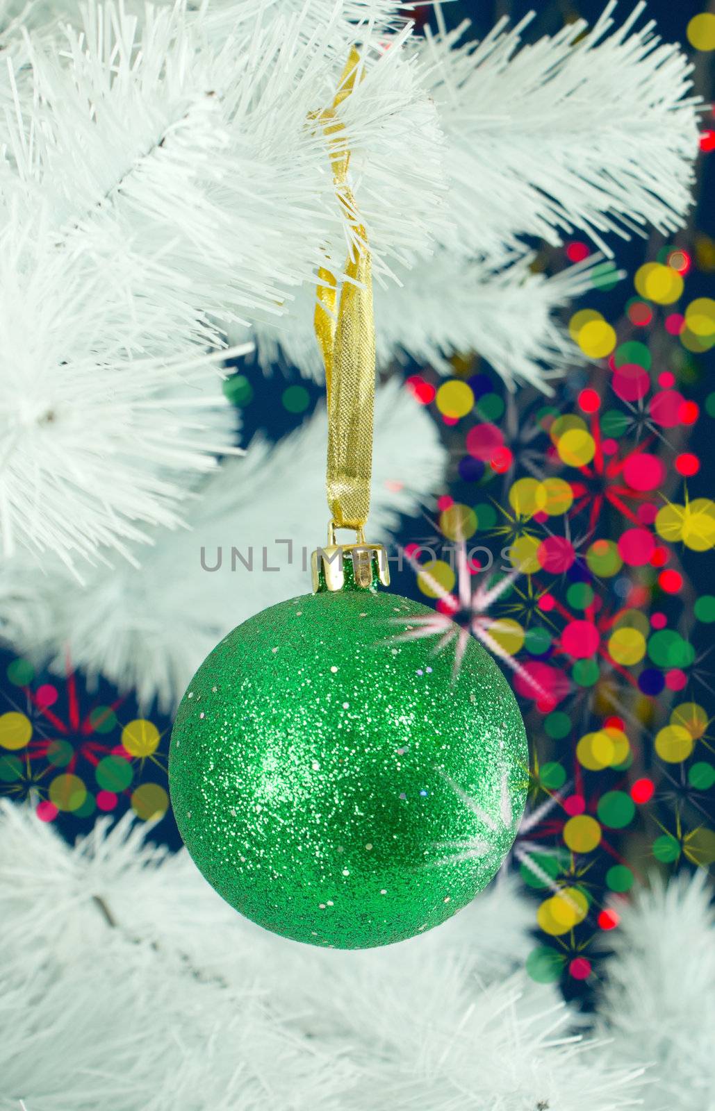 Green ball hanging on the Christmas tree