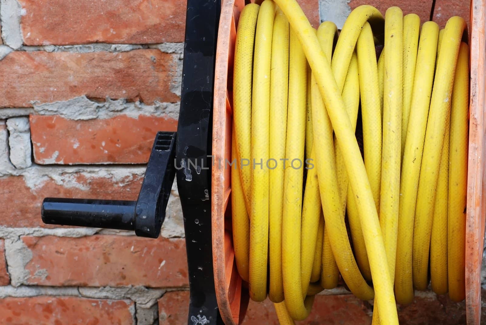 details of yellow garden hose on spool