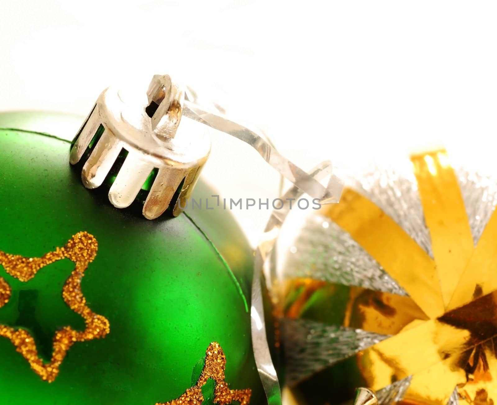 two christmas balls with golden details over white background macro