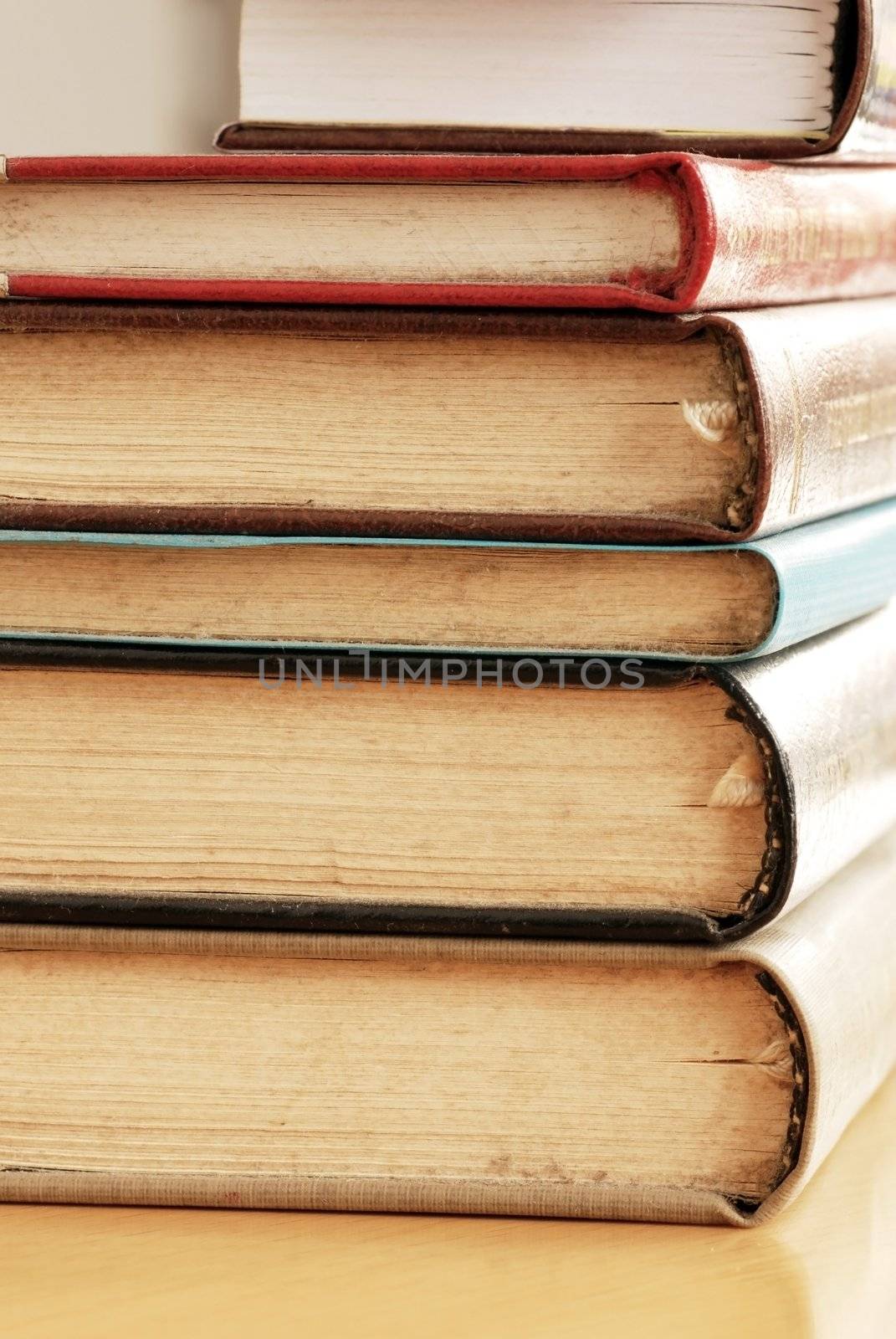 old dusty closed books stack on table