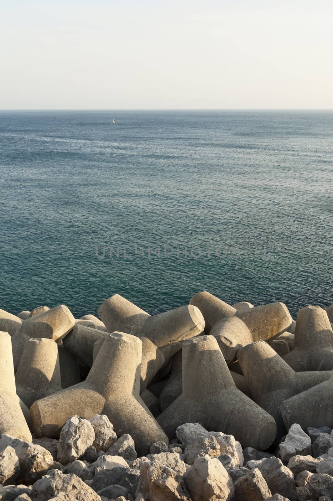 Concrete tetrapod  breakwater in the shore near Sesimbra, Portugal