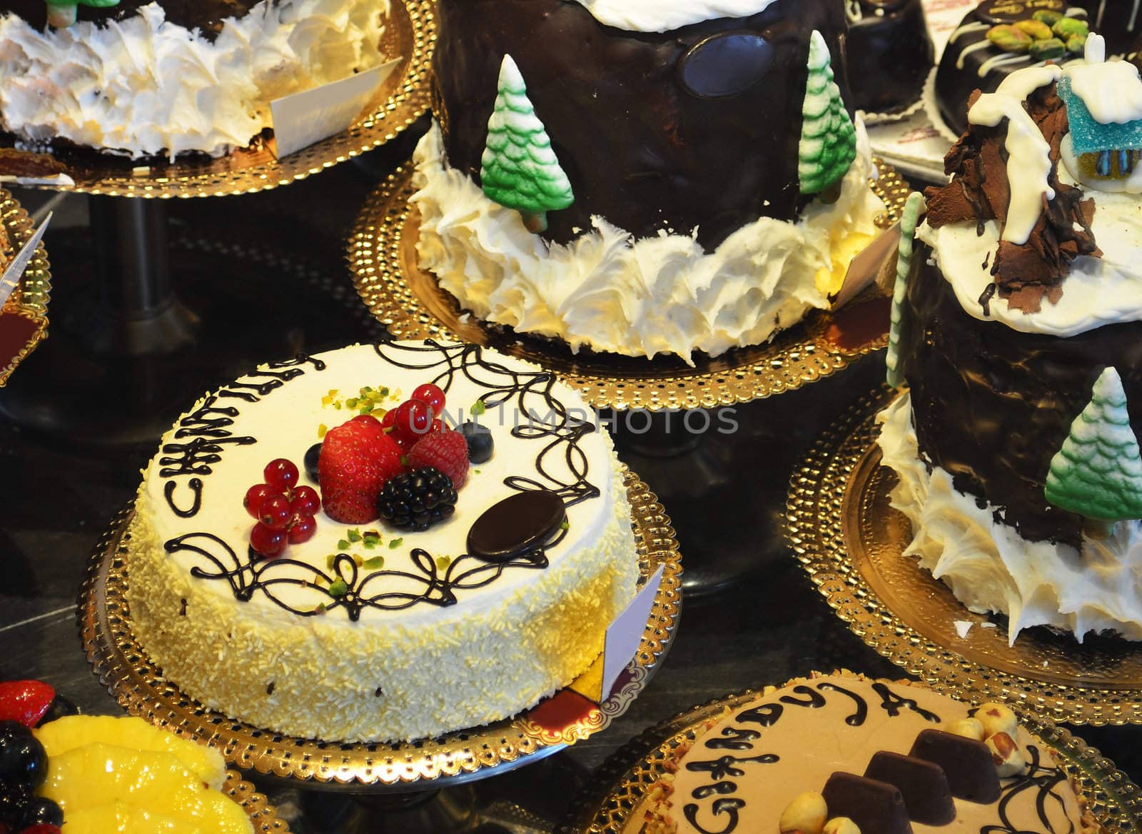 Colorful fancy gourmet cakes with cream, chocolate, fruit