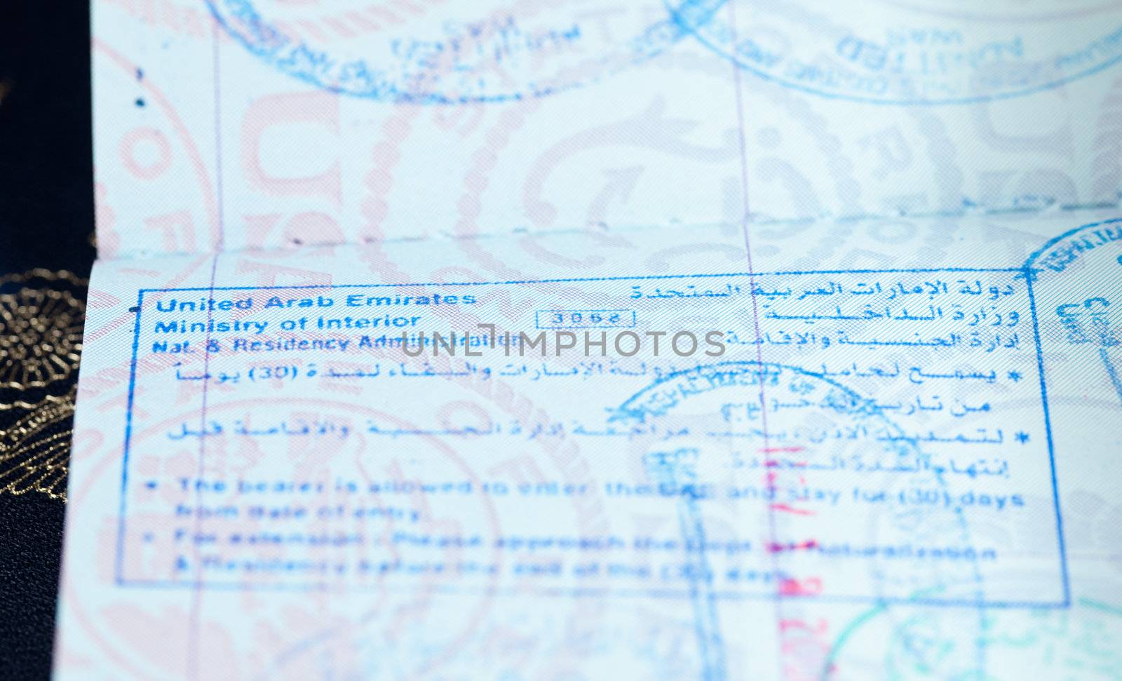 Macro image of visa and immigration stamps in US passport for Dubai or Abu Dhabi in the UAE