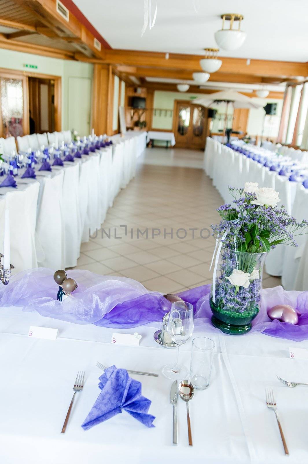 Vertical view of a festive hall decorated in white and purple