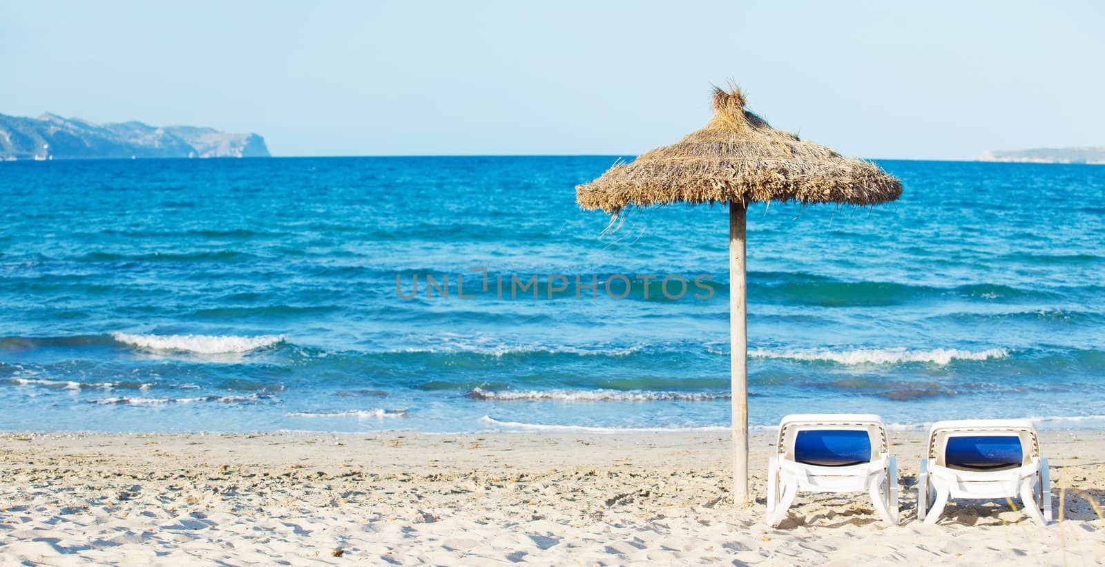Panorama. Tropical beach with umbrella and sun loungers