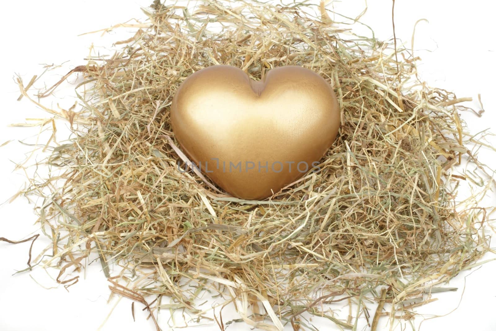 Golden heart in a bed from straw