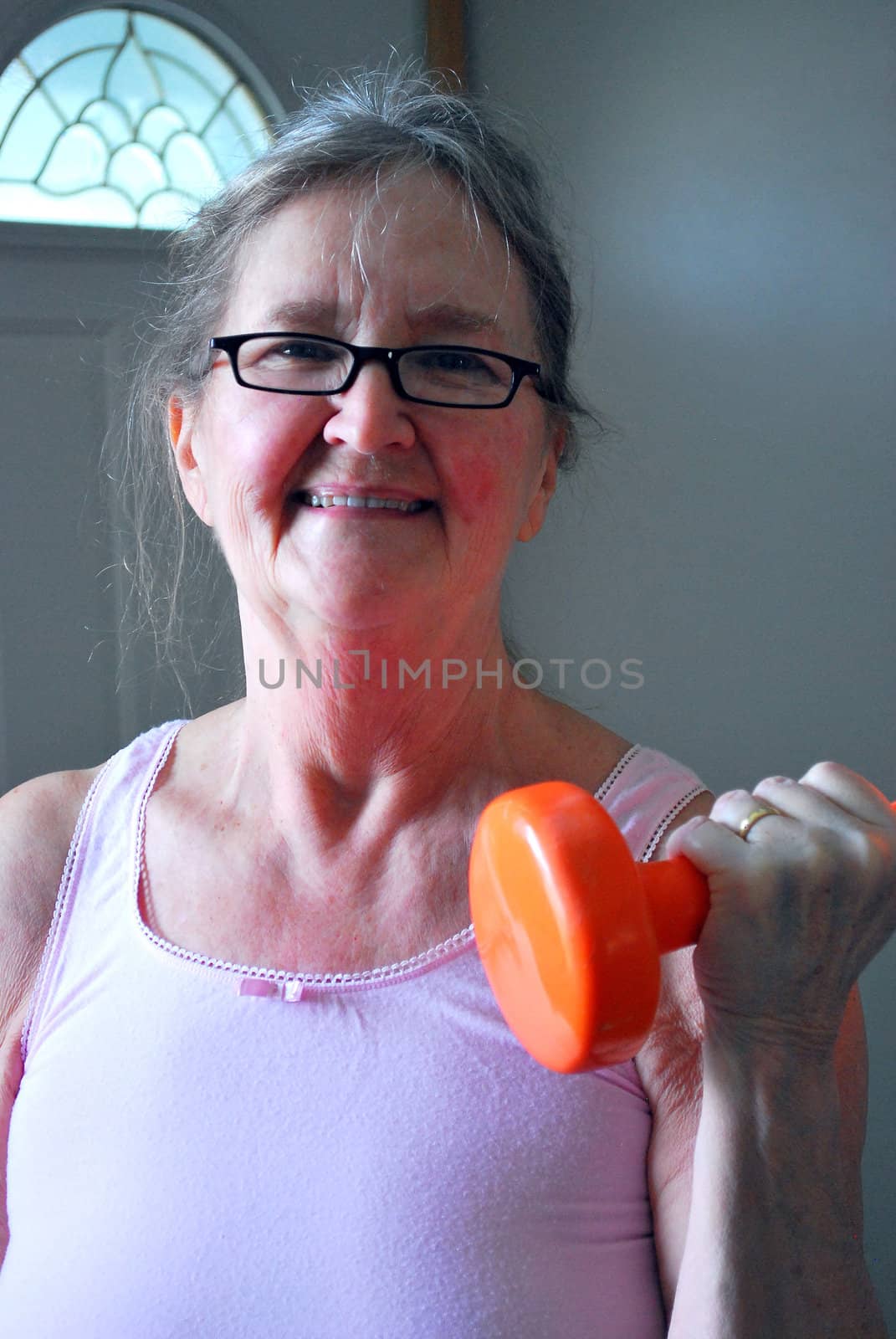 Mature female working out at home.