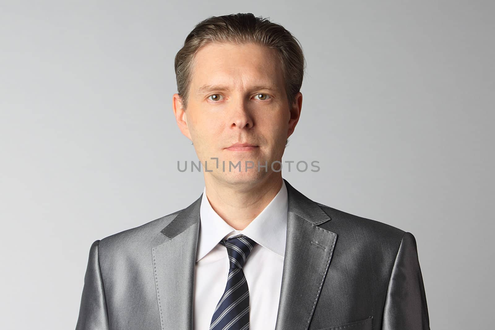 portrait of middle age businessman in austere suit