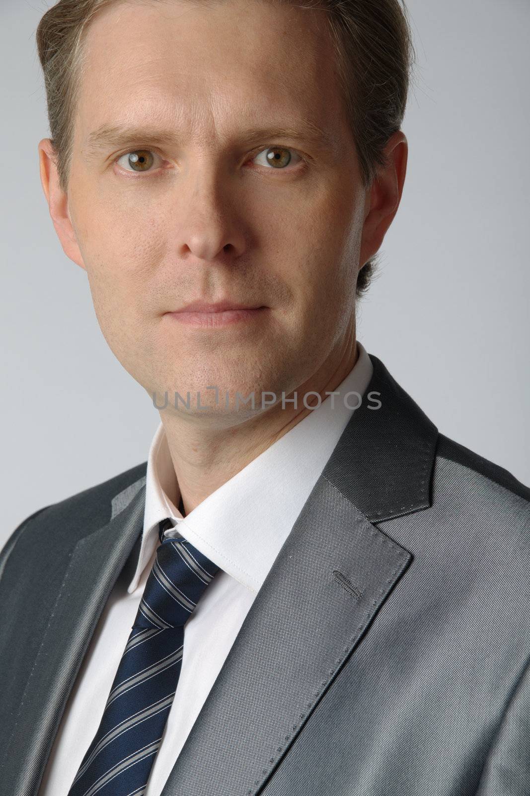 portrait of middle age businessman in austere suit