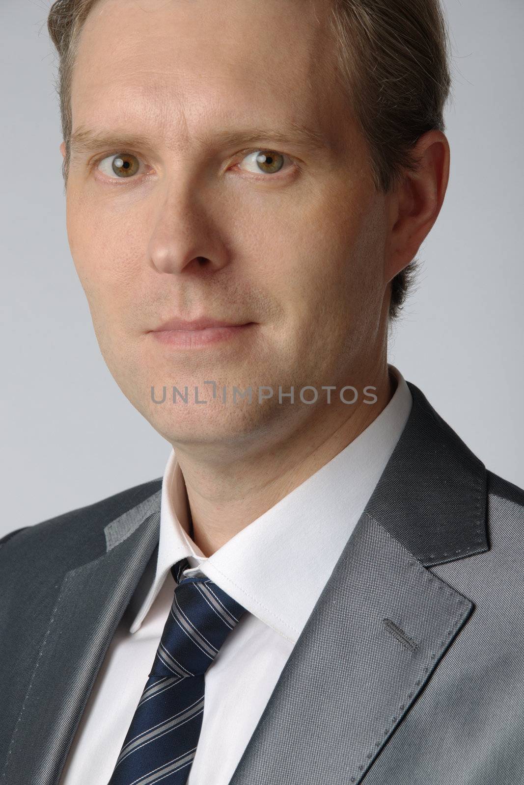 portrait of middle age businessman in austere suit