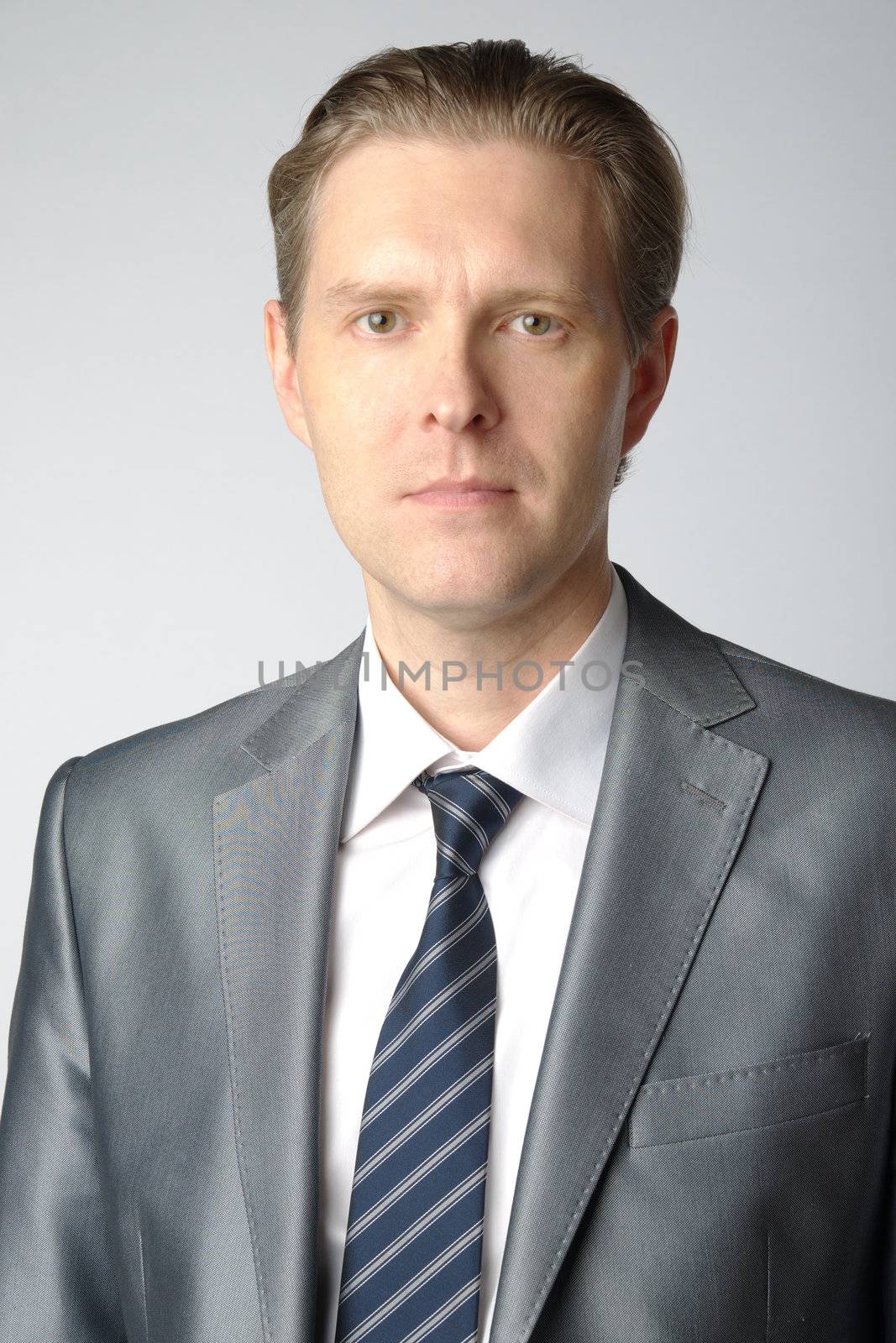 portrait of middle age businessman in austere suit