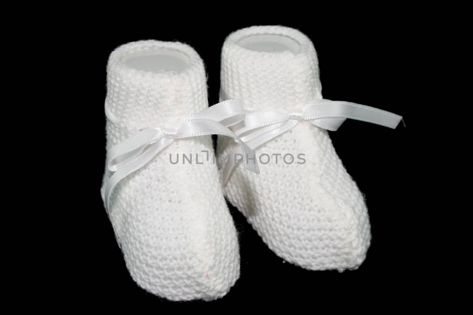 white baby socks with horizontal ties with black background