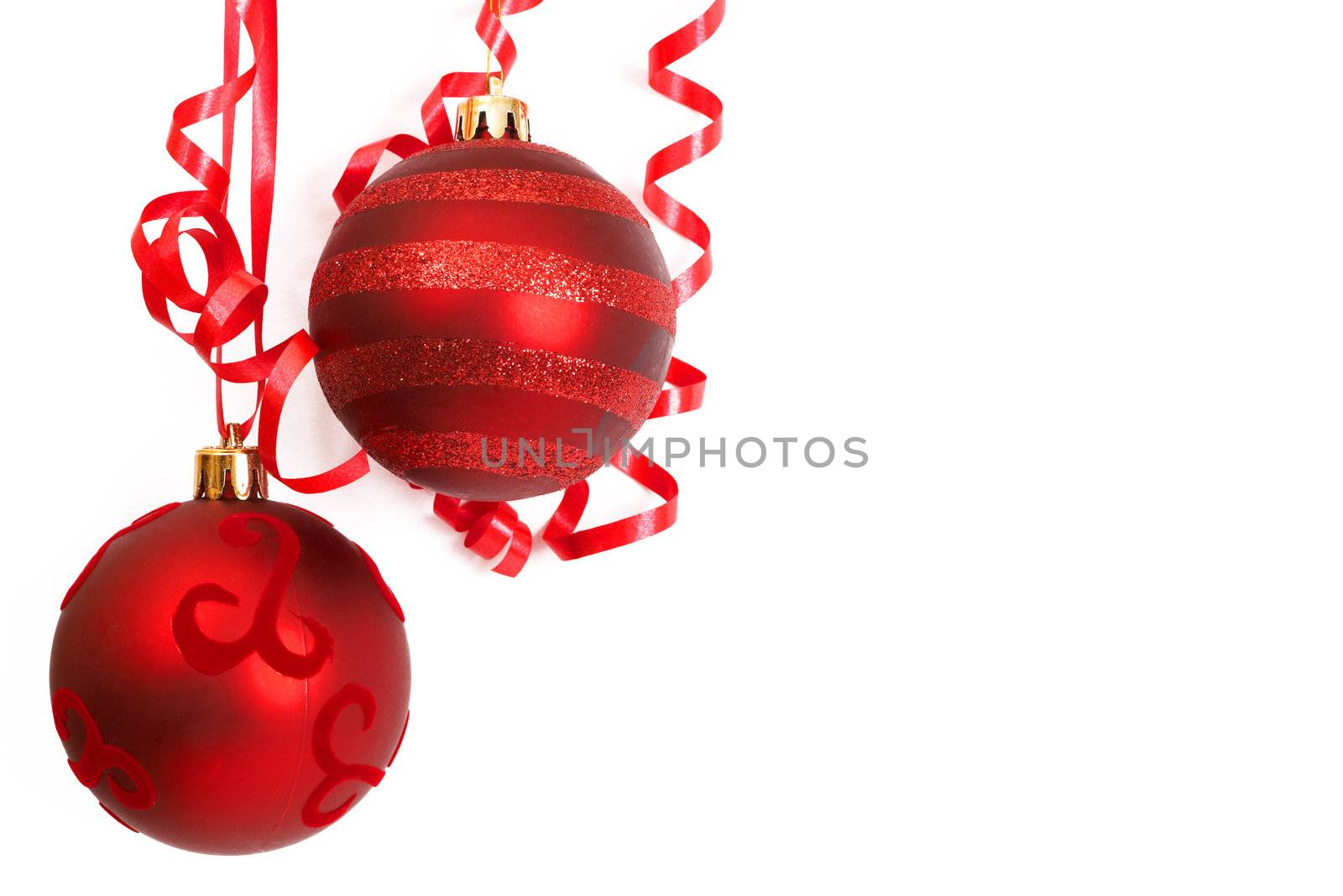 Three red Christmas baubles isolated on white background with copy space. 