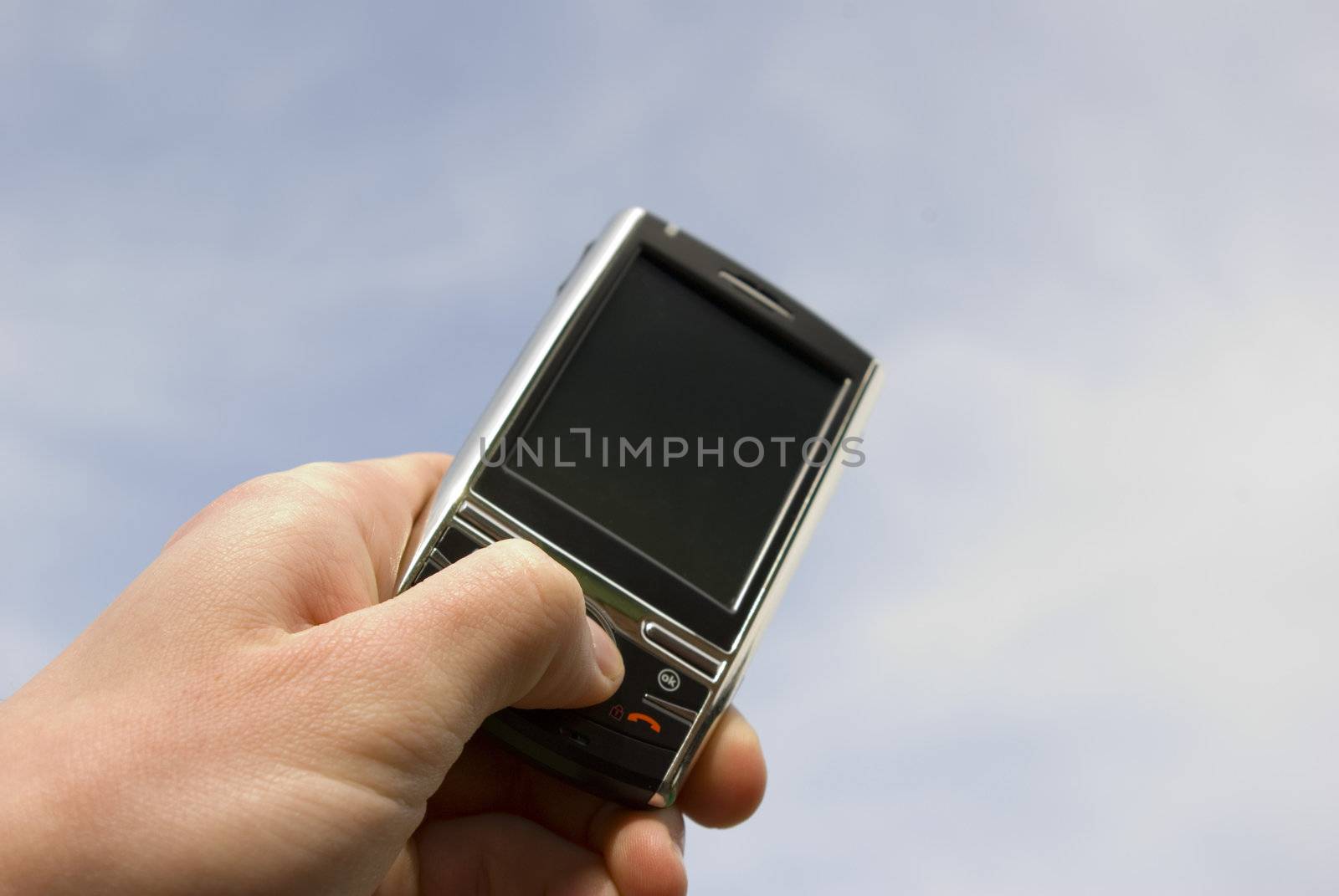 a hand holding a mobile phone for support             