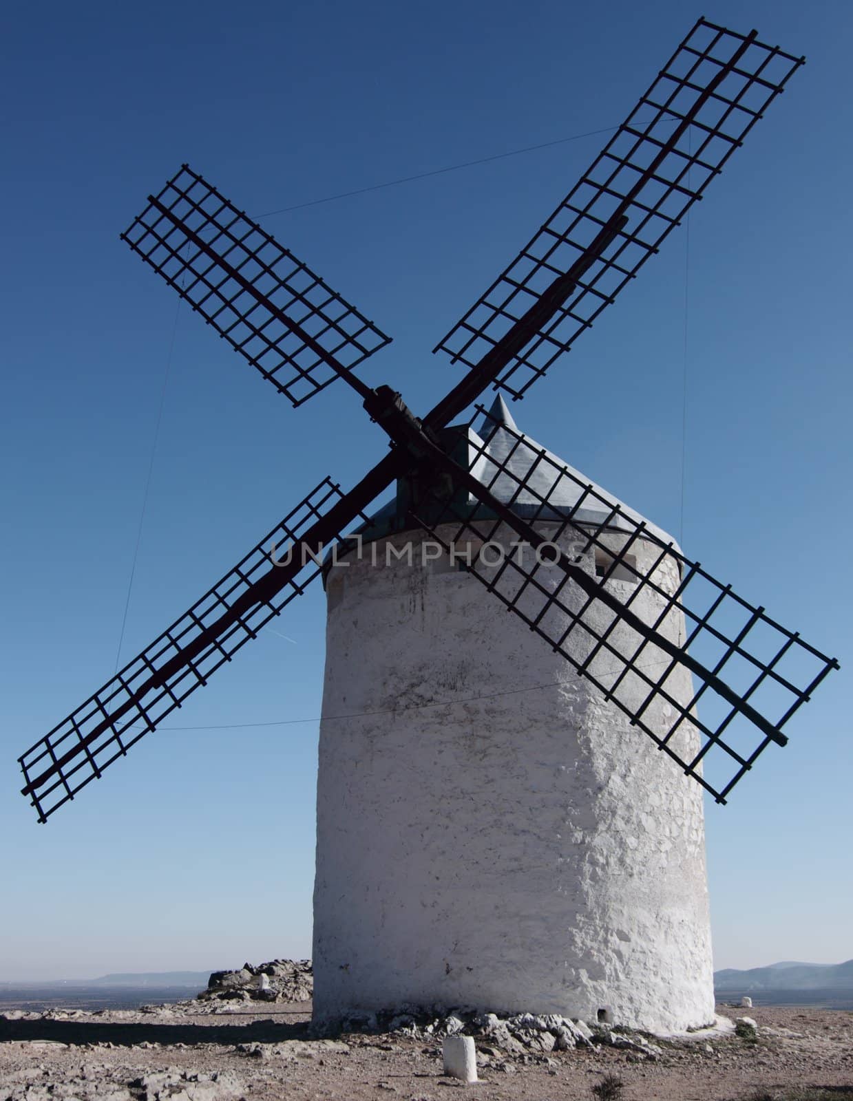 an old and vintage windmill in spain village