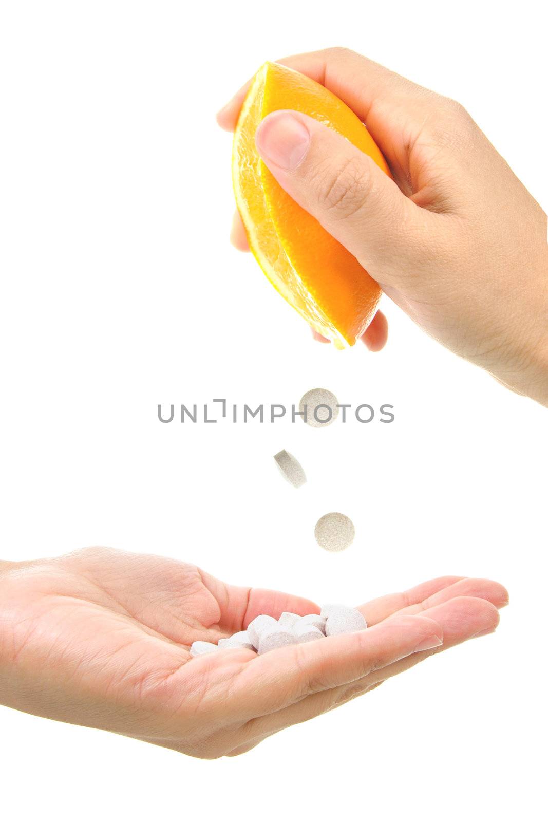 Conceptual image of vitamin C tablets being squeezed out of an orange