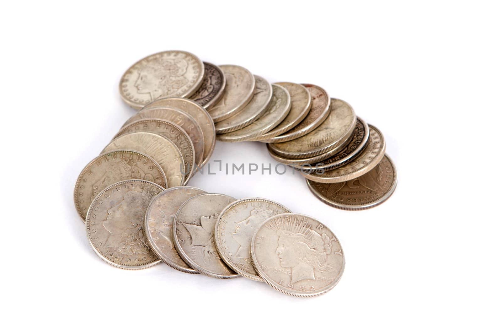Old USA silver dollars money positioned on a white background.