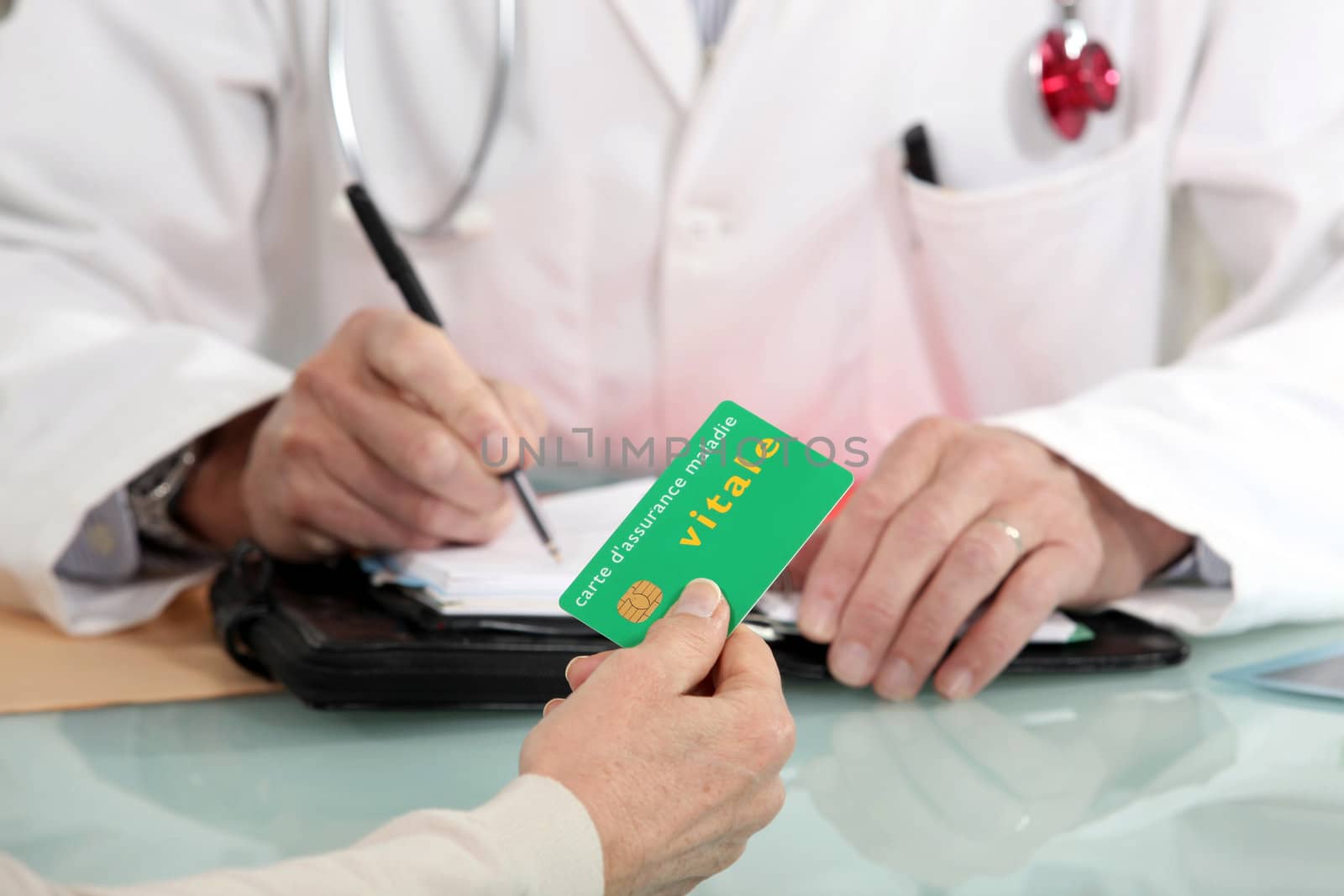 a patient giving a card to a doctor by phovoir