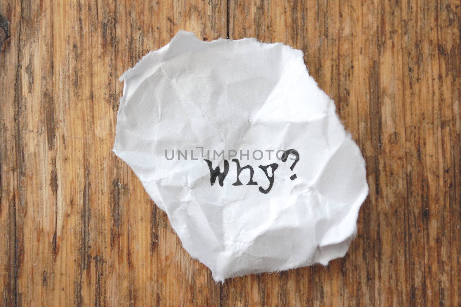 The word why on a crumpled piece of paper
